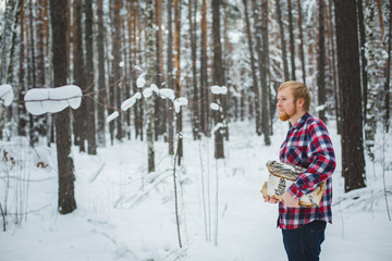 the man in the plaid shirt carries firewood