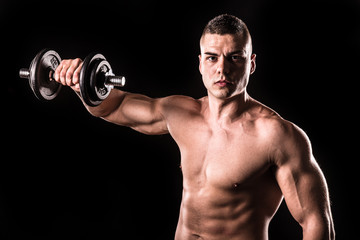 Fototapeta na wymiar muscular young man lifting weights isolated with black background