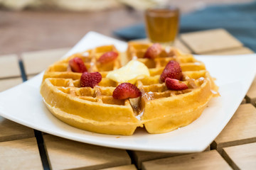 butter waffle with honey and strawberry