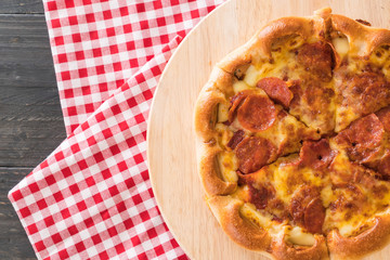 Homemade Pepperoni Pizza on wood plate