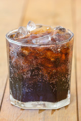 Cola soda in glass with ice