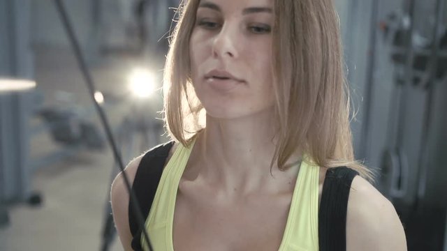Close up of girl workout with simulator in the gym in 4K