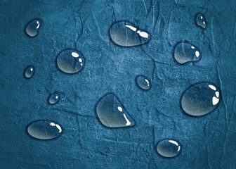 Transparent water drops on blue background. Concrete Wall Textured Backdrop Surface
