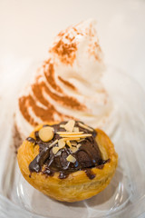 Brownie tart with sliced almond and vanilla ice cream