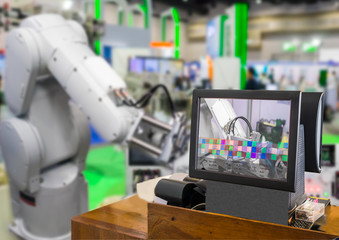 Industry 4.0 and Augmented reality for industry concept. Robotic and Automation system control application on computer screen on automate robot arm in smart manufacturing background.