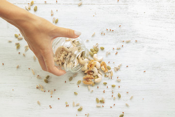 Seeds and nuts are spilling from the jar
