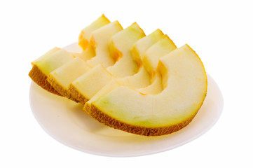 Ripe fresh cantaloupe slices on white plate