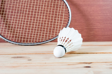 the BADMINTON white Shuttlecock and racket on nature wooden background