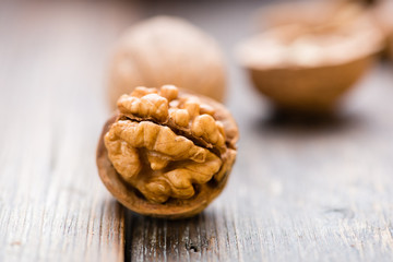 Walnuts on wooden table. Macro. Front view