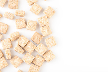 pieces of brown cane sugar isolated on white background with copy space. Top view.