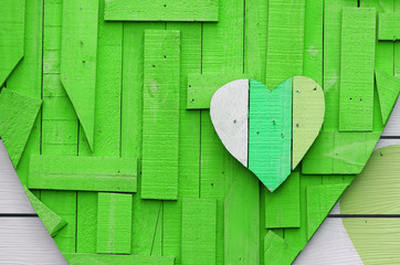 Heart shape on green background made from recycle wood for valentine day