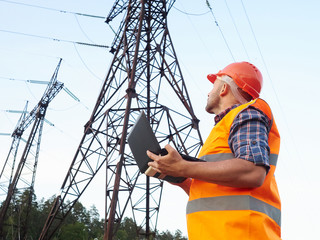 Electrical engineer working. Talking on the phone and working wo