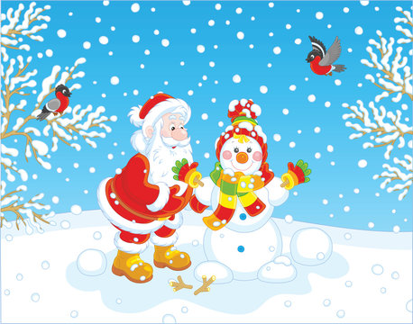 Santa Claus making a funny smiling snowman with a cap, a scarf and mittens