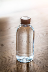 Plastic water bottle on wooden table texture