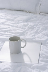 Fototapeta na wymiar Bed with coffee cup on tray