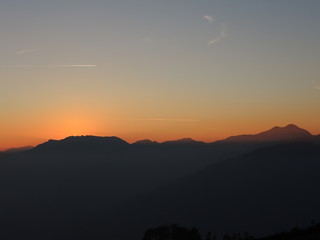 Fiery sunset from mountain pick in a clean evening. Fall season. Orobie alps.