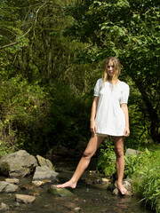 Young woman standing in stream