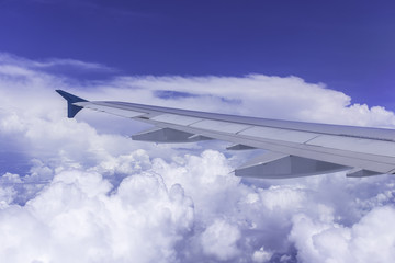 Clouds and sky as seen through window of an aircraft
