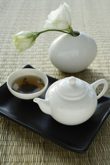 Tea and vase with lisianthus flower