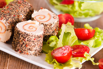 Goat cheese with salad and cherry tomatoes. 
