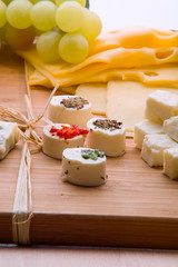 Cheese platter with different cheese and grapes