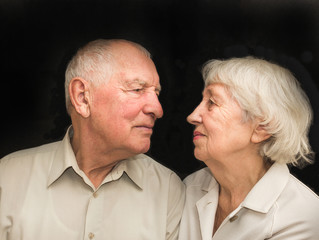 The elderly couple on a black background