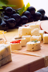 Cheese platter with different cheese and grapes