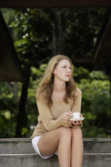 woman having coffee on steps