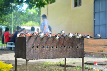 Skewers with meat on a char grill.