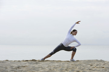 woman stretching on beach