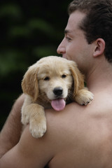 man holding puppy