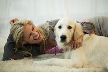 blond woman playing with her dog