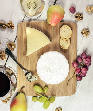 Tasting with glasses of wine and different cheese types