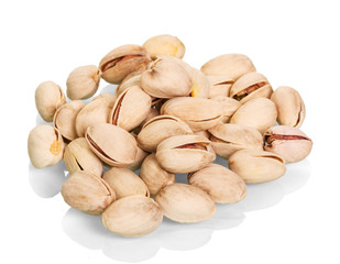 Roasted pistachios close-up isolated on white.