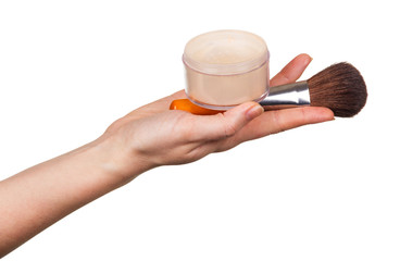 Female hand holds jar powder and cosmetic brush isolated.