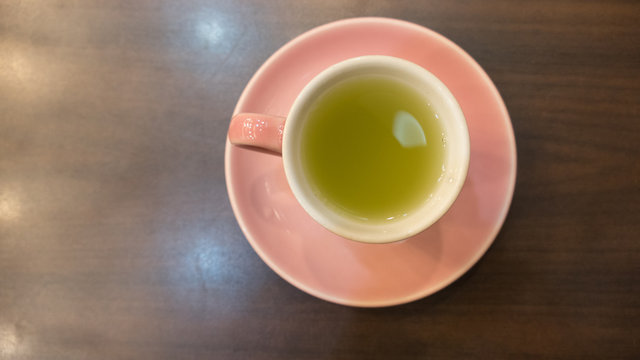 hot green tea in pink cup