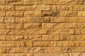 Stone tile wall background, yellow stone tile design
