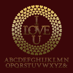Gold patterned letters with tendrils. Vintage font in romantic style. Isolated english alphabet with text I Love U in hearts frame.