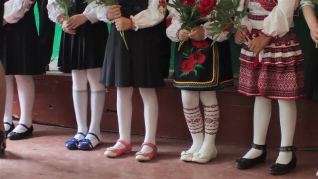 standing in a row feet girls/legs in white stockings standing in the holy in the classroom