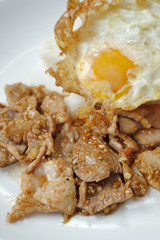 fried egg with garlic pork topped on rice, asian street food