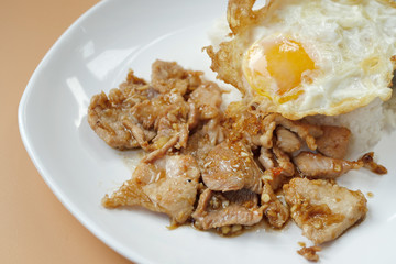 fried egg with garlic pork topped on rice, asian street food