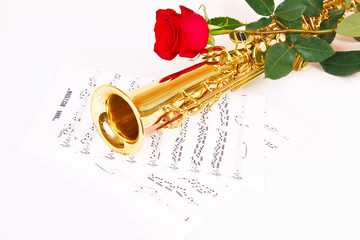 Naklejka premium Red rose, saxophone and music sheet