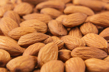 Almonds background. Pile of selected almonds close-up. For vegetarians.