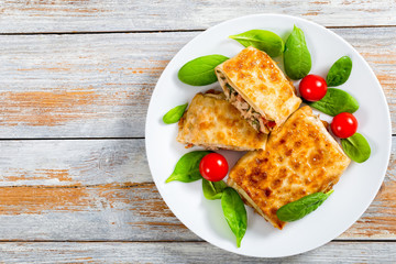 fried flatbread wraps Stuffed with meat on white dish