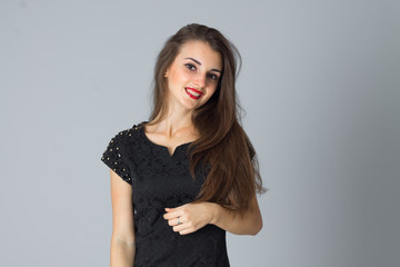 girl in black dress posing in studio