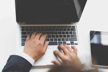 businessman typing on laptop computer in office