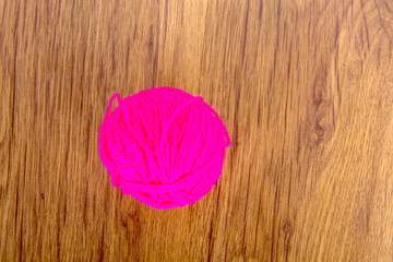 Bright balls of acrylic yarn on a wooden table. Needlework. Knit and Crochet. Fashion trends.