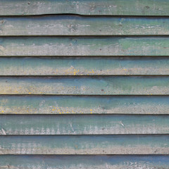 square part of shed wall consisting of old wooden planks with fa