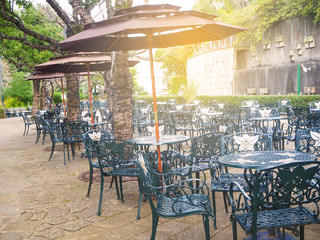 Metal table set with chairs in the rest area of Glovergarden, the tourist attraction in Nagasaki, Japan