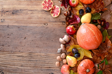 above flatlay view with copyspace in a frame of autumn theme vegetable and fruit in a wood table